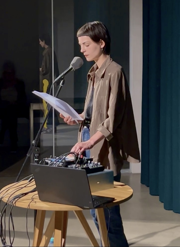 Person reading poetry into microphone