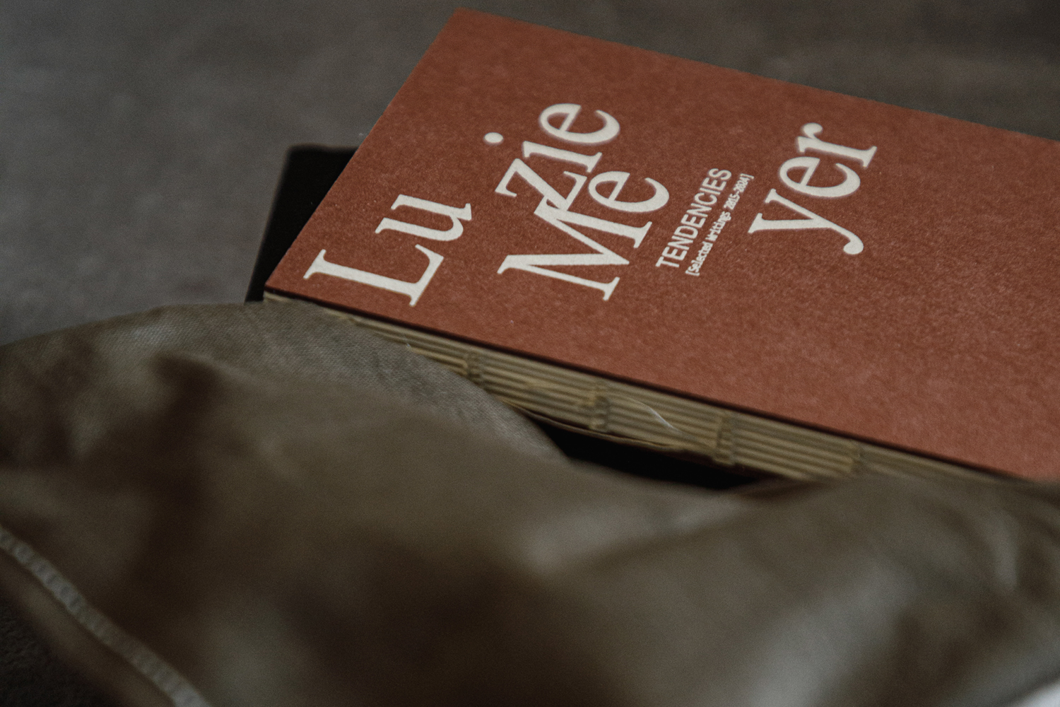 small orange book half blurry on pillow