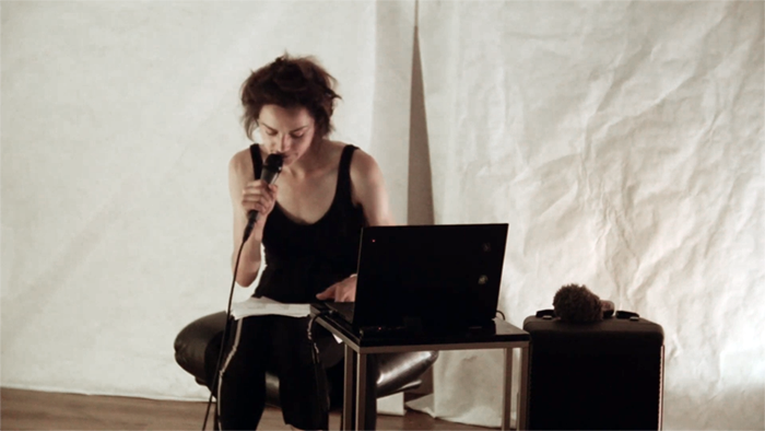 woman in dimly lit cozy atmosphere speaking into microphone